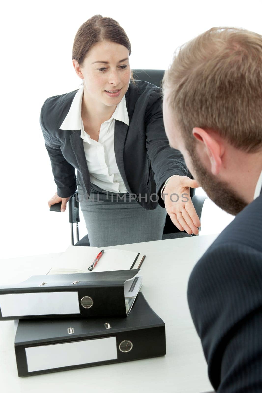 beard business man brunette woman at desk ask sit down