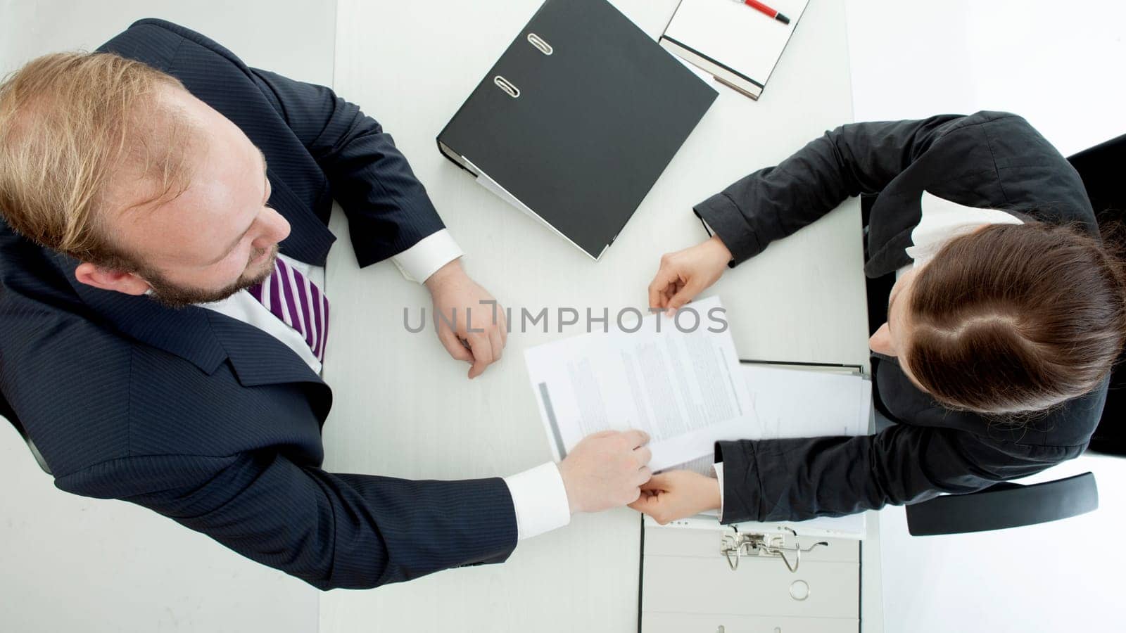 beard business man brunette woman at desk working above