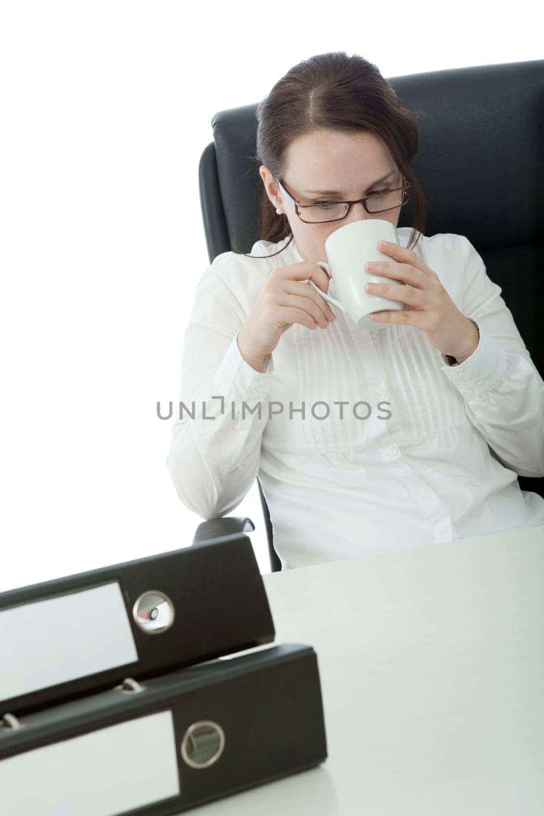 young brunette businesswoman with glasses relaxing and drinking coffee