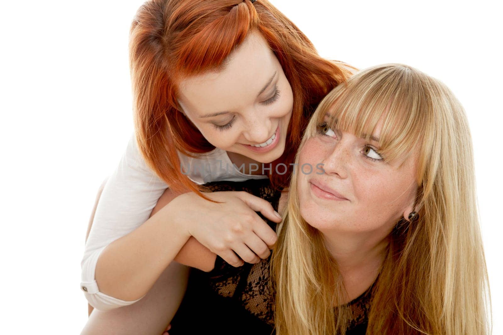 young beautiful red and blond haired girls in front of white background