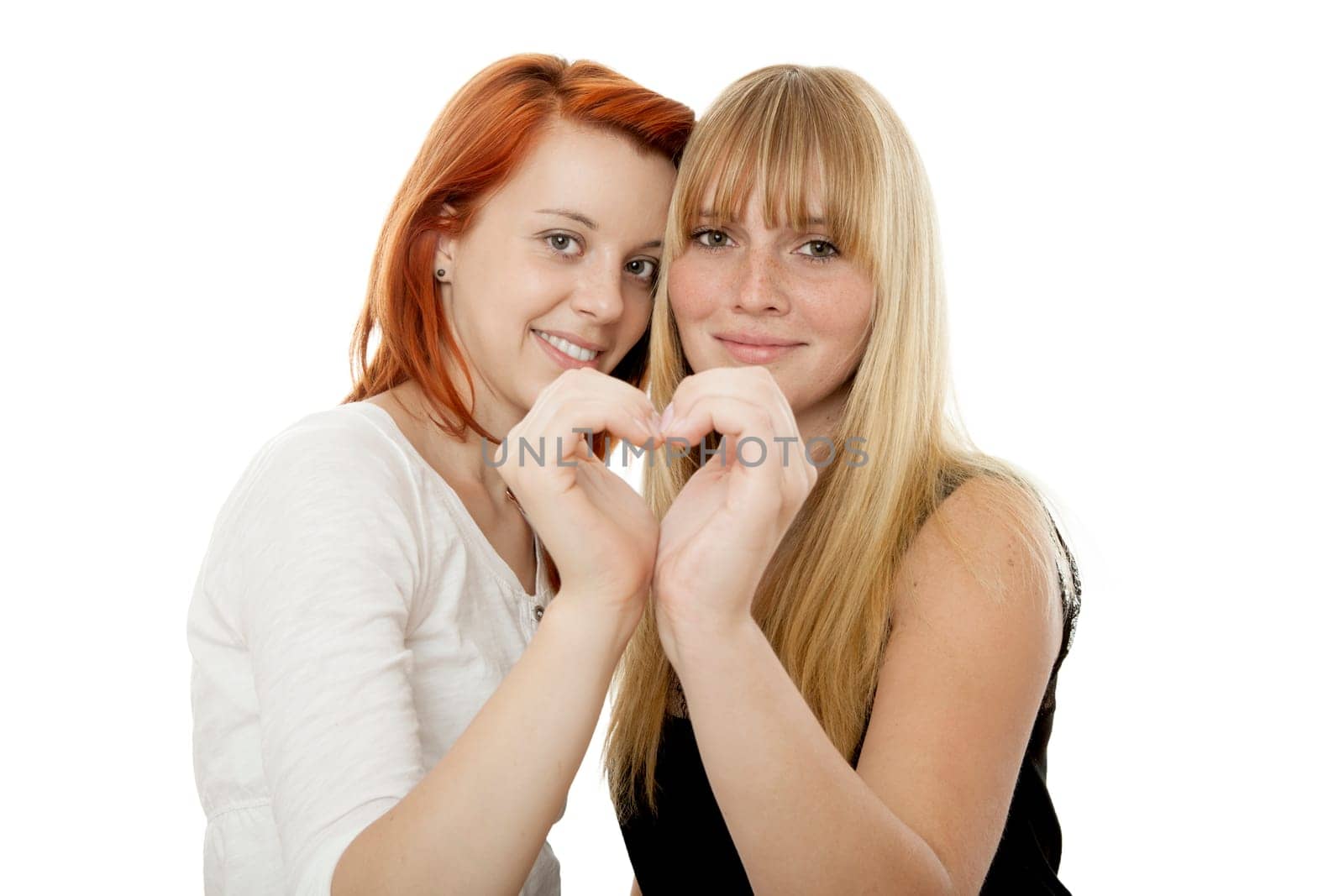 young beautiful red and blond haired girls in front of white background