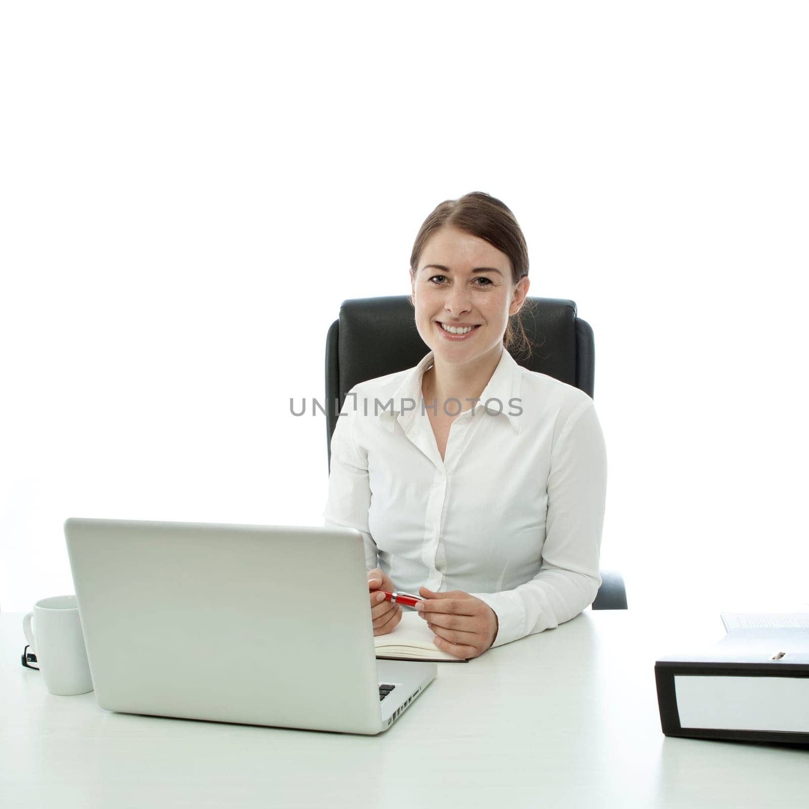 young brunette business woman smiling behind desk