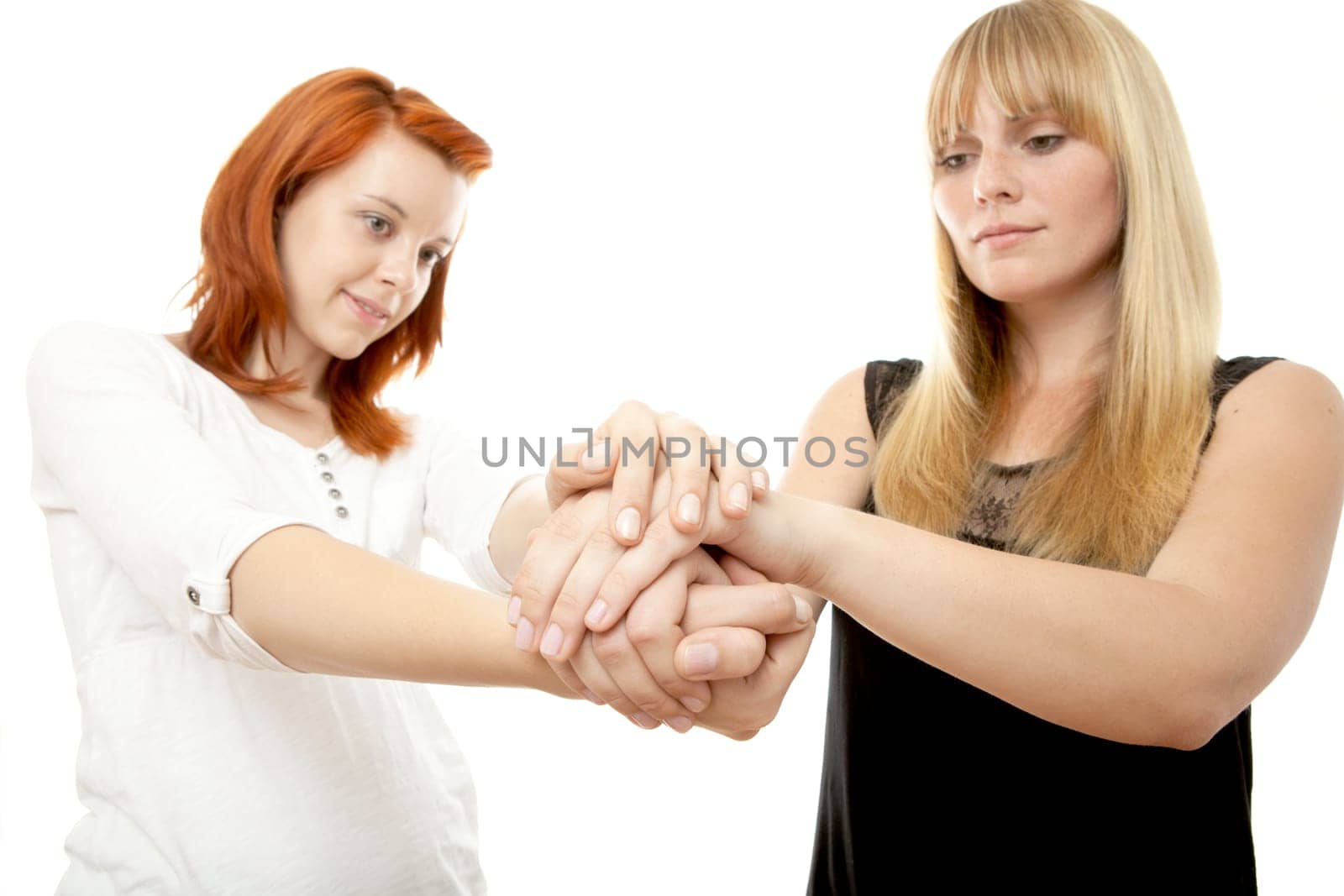 young beautiful red and blond haired girls in front of white background