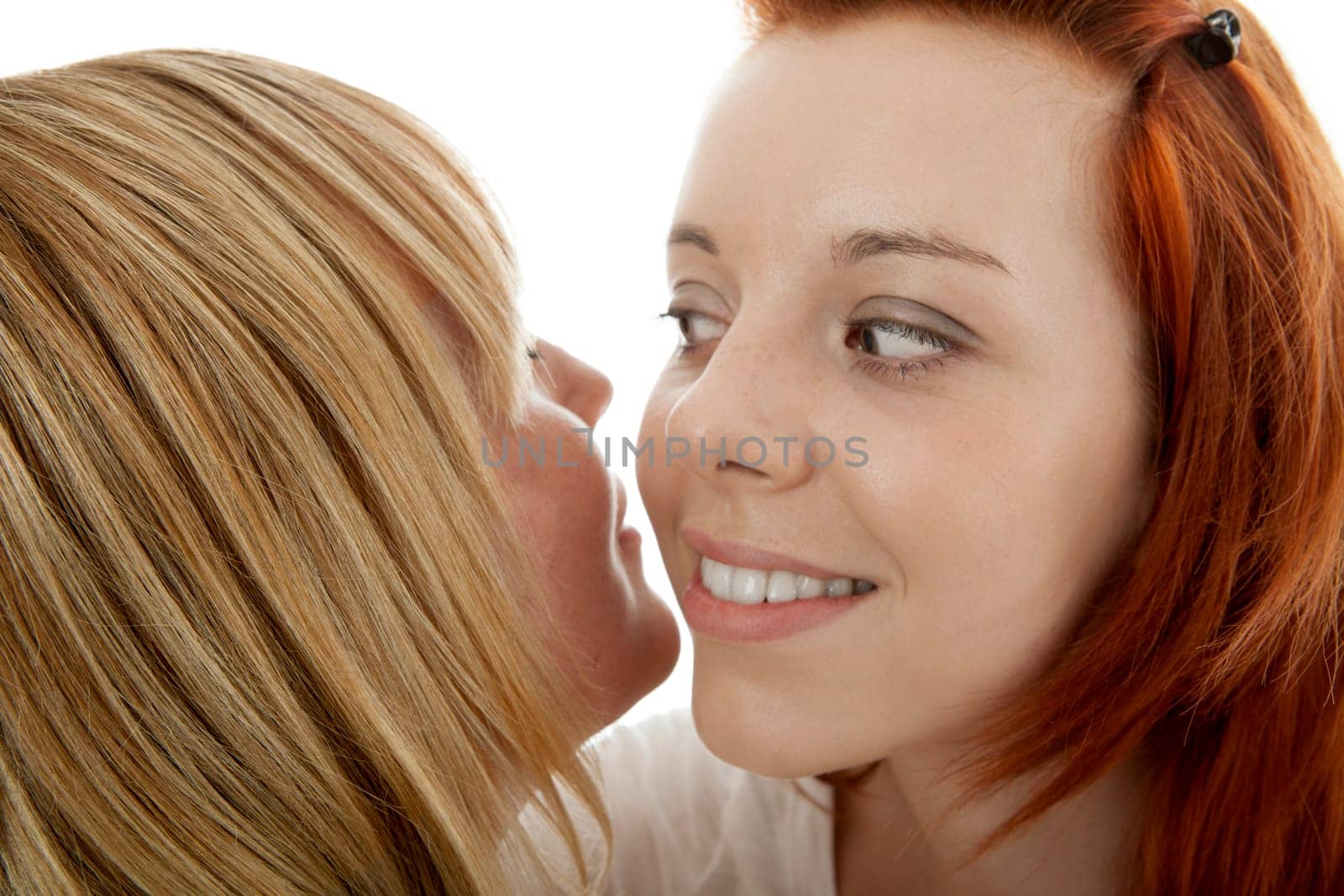 young beautiful red and blond haired girls in front of white background