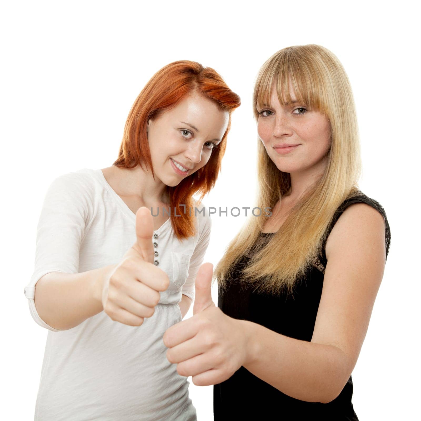 young beautiful red and blond haired girls in front of white background