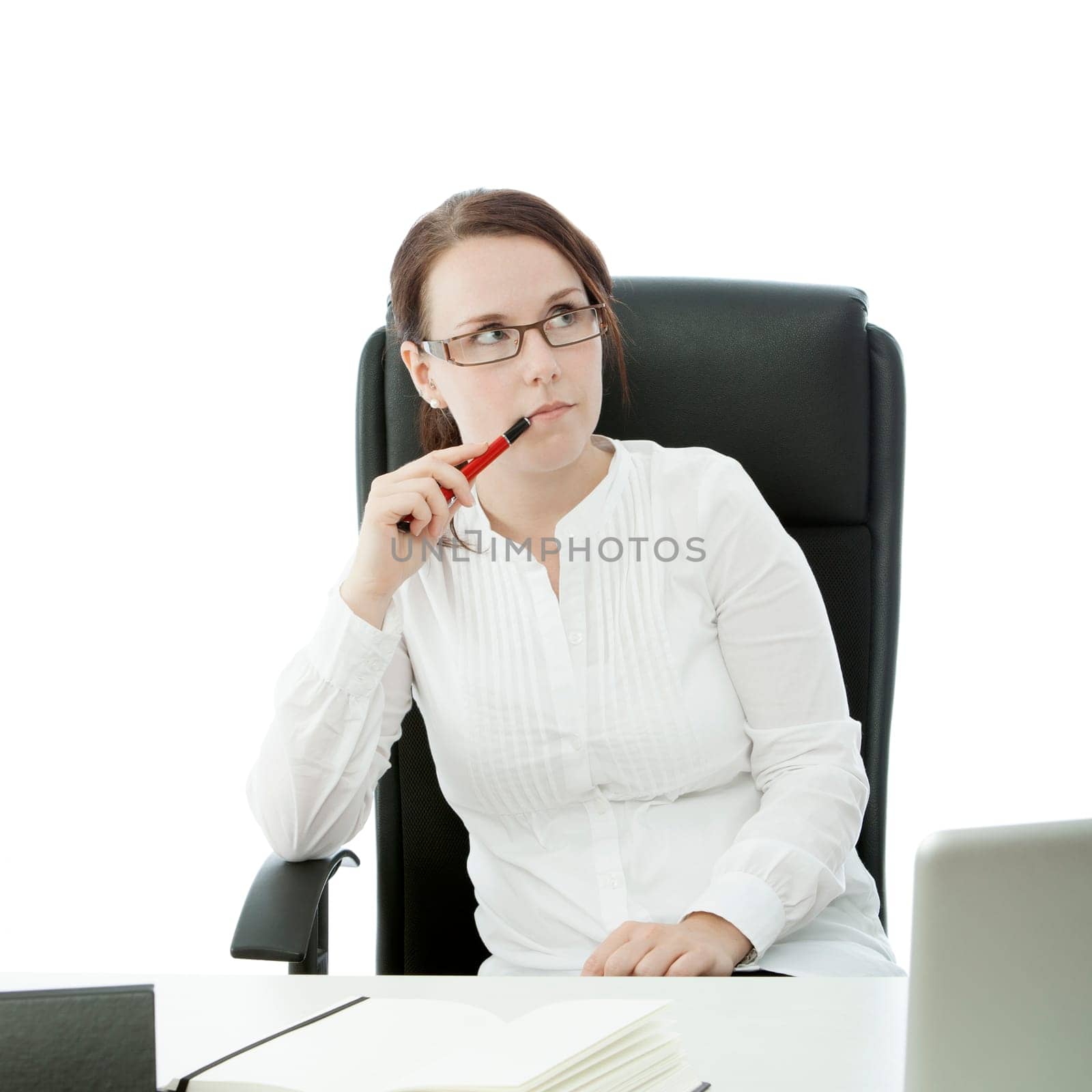 young brunette businesswoman with glasses and pen thinking on desk