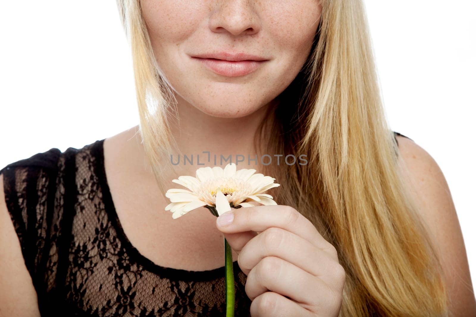 young beautiful blond haired girl playing he loves me in front of white background