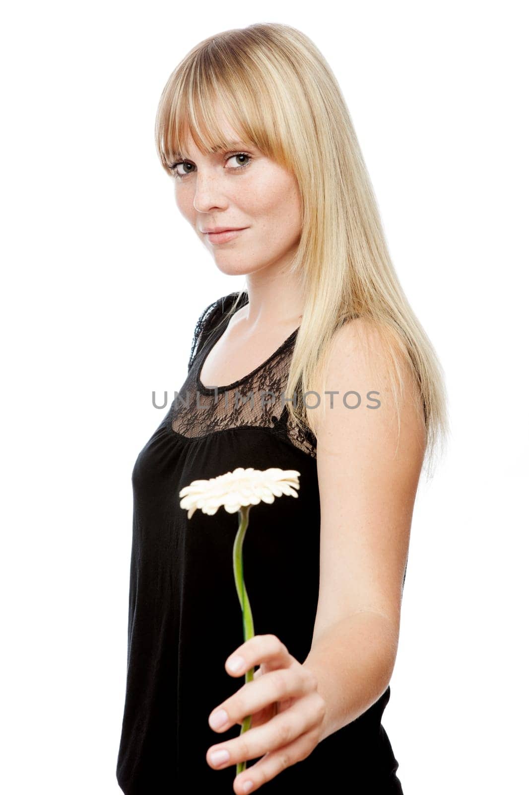 young beautiful blond haired girl gives you a flower in front of white background
