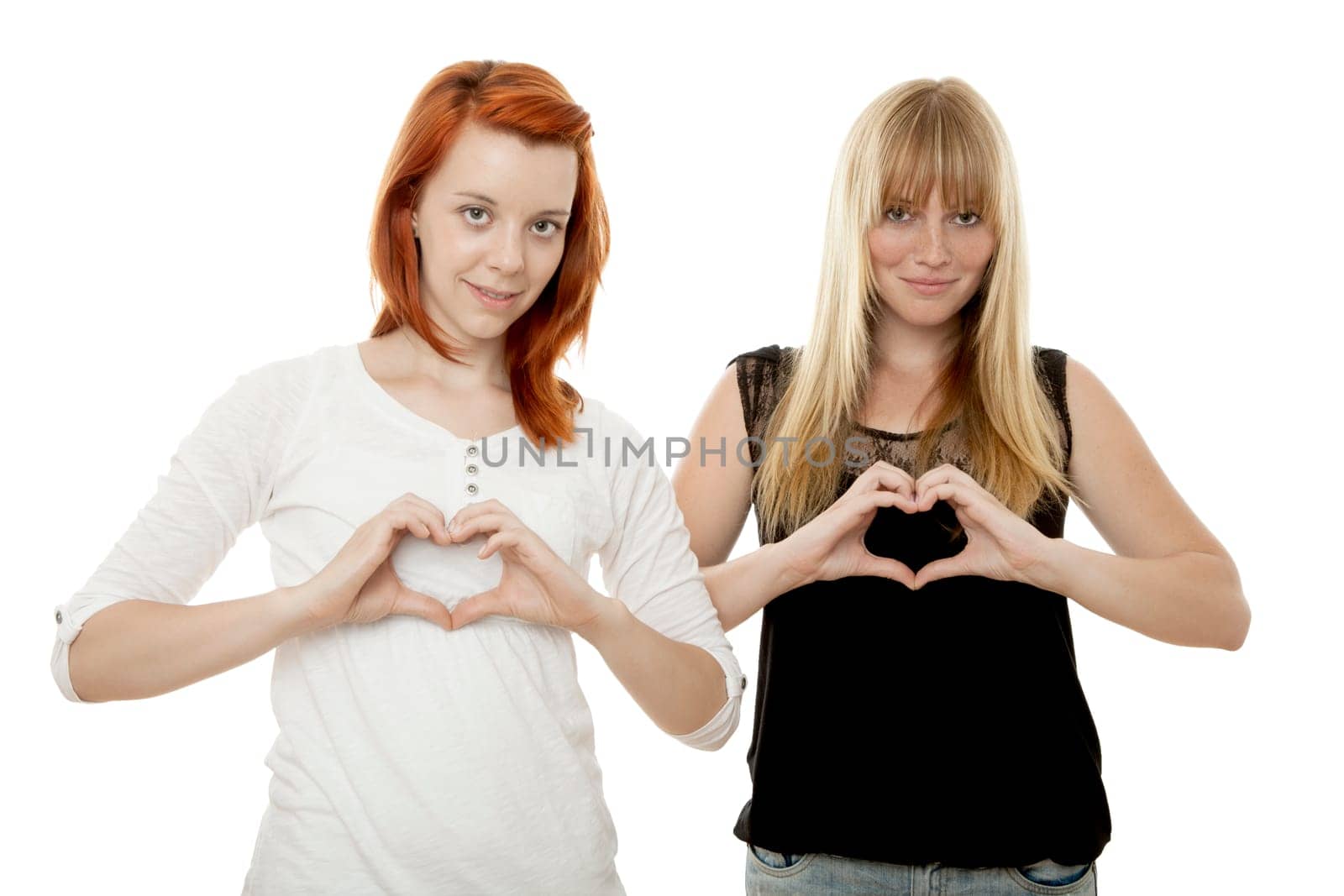 young beautiful red and blond haired girls in front of white background
