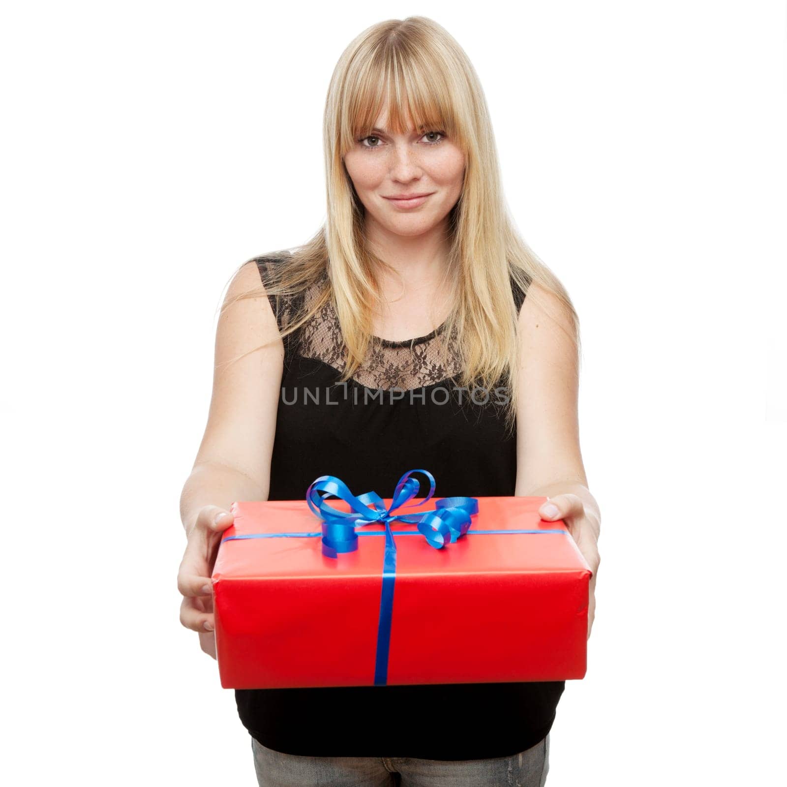 young beautiful blond haired girl has a gift for you in front of white background