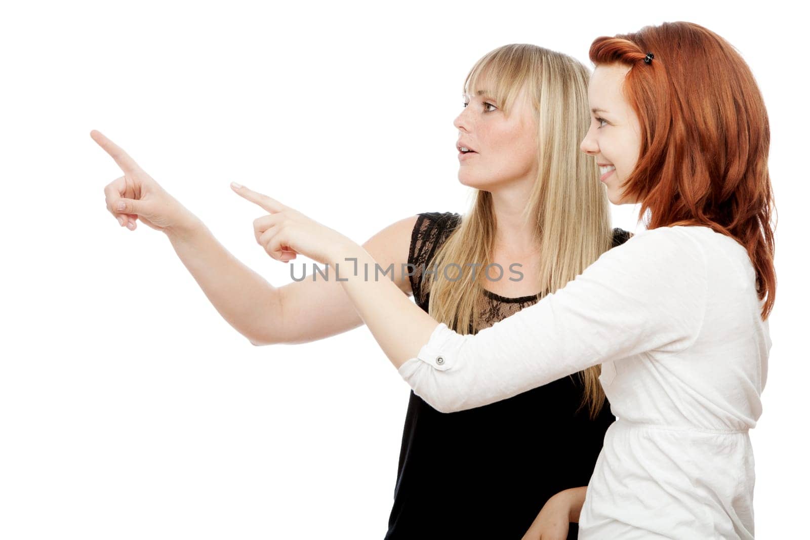 young beautiful red and blond haired girls in front of white background