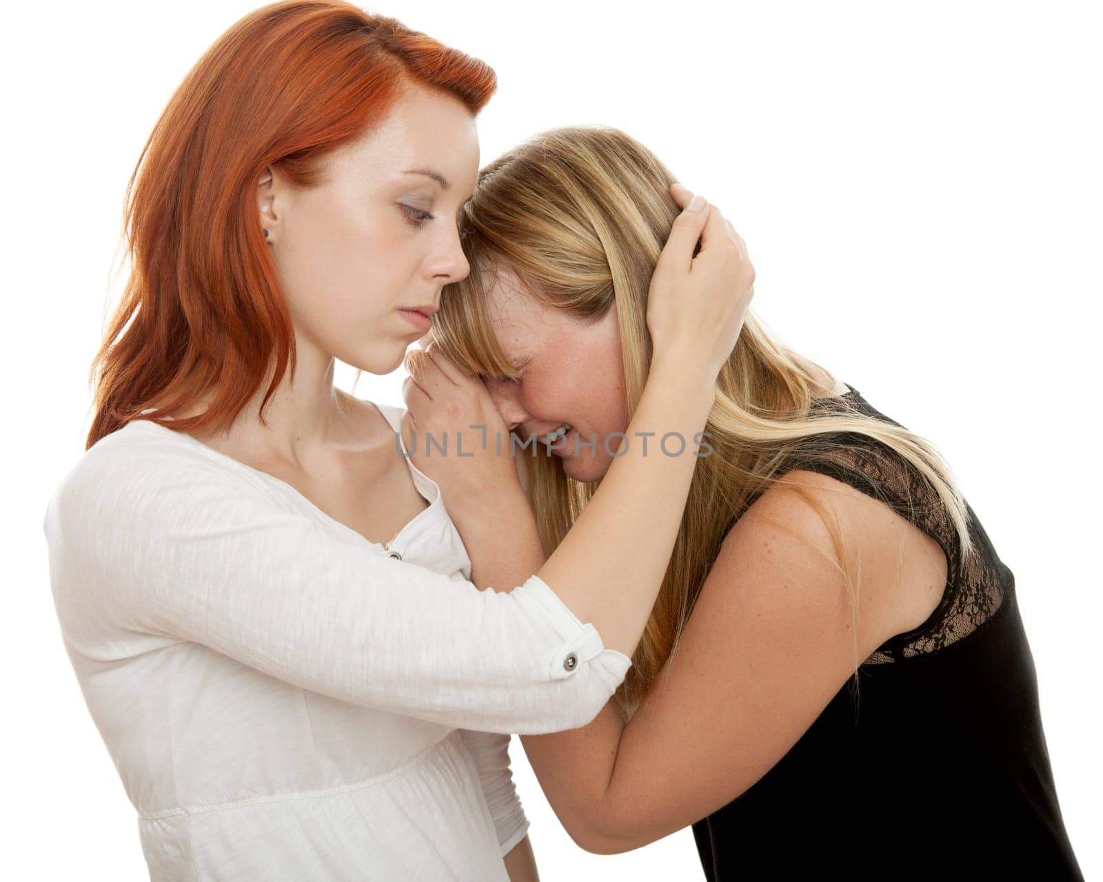 young beautiful red and blond haired girls in front of white background