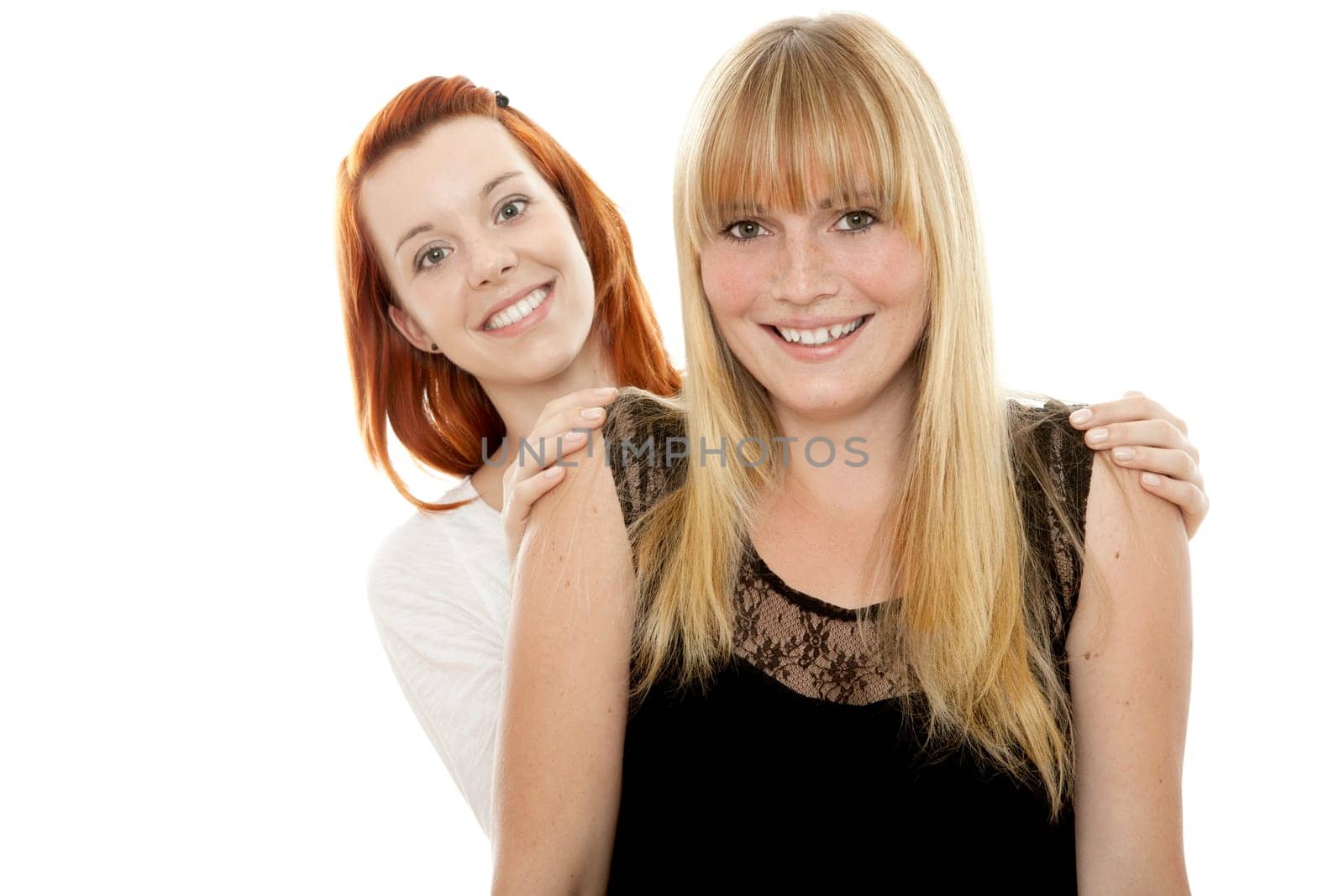 young beautiful red and blond haired girls in front of white background
