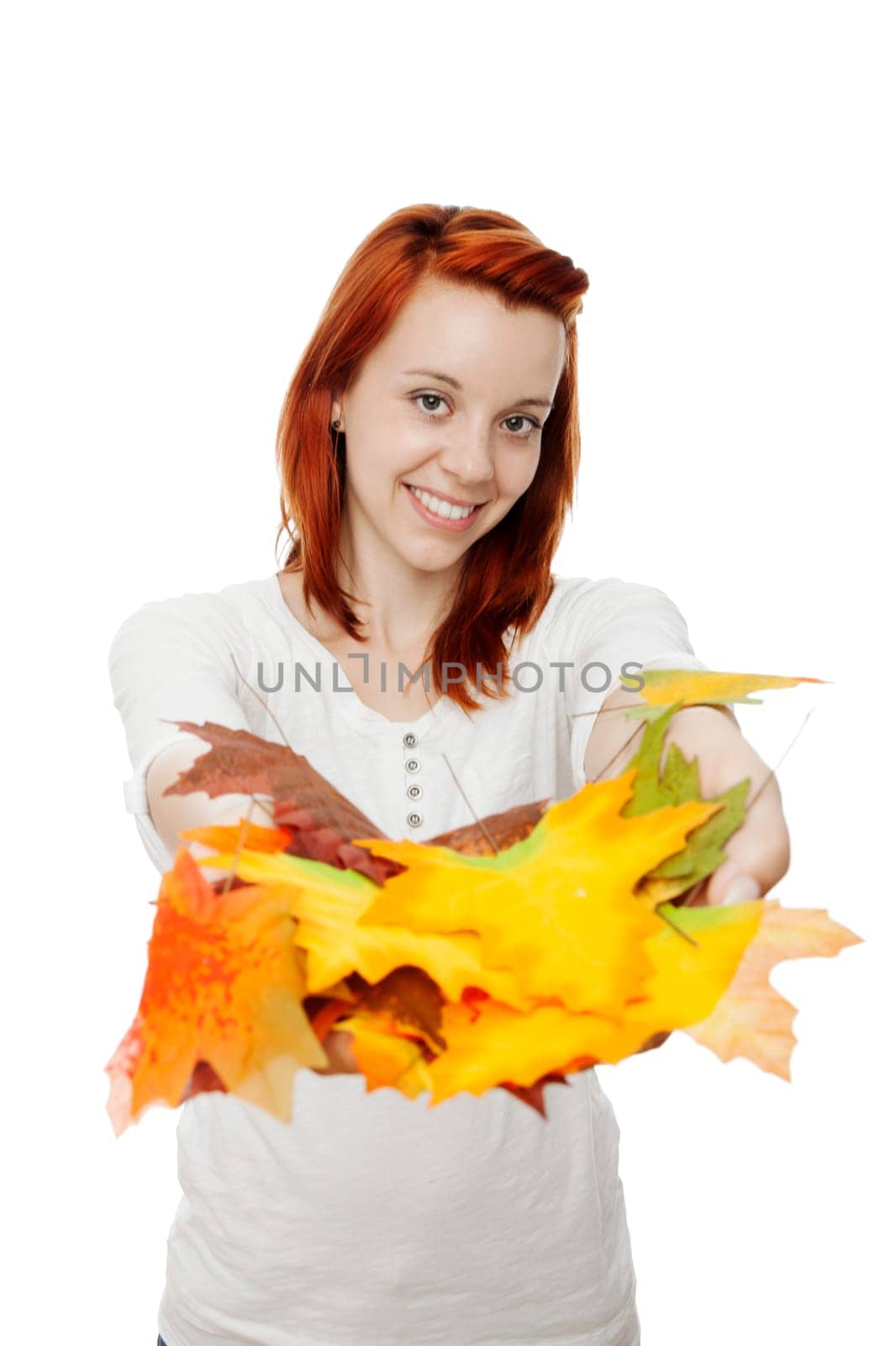 young beautiful red haired girl with leaves in her hands in front of white background