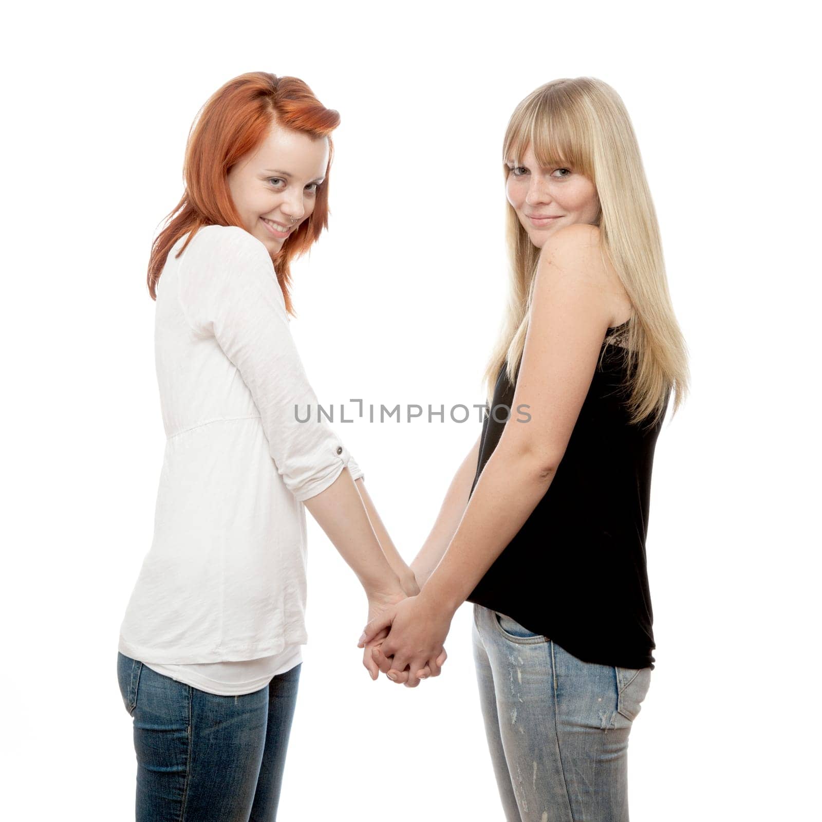 young beautiful red and blond haired girls in front of white background