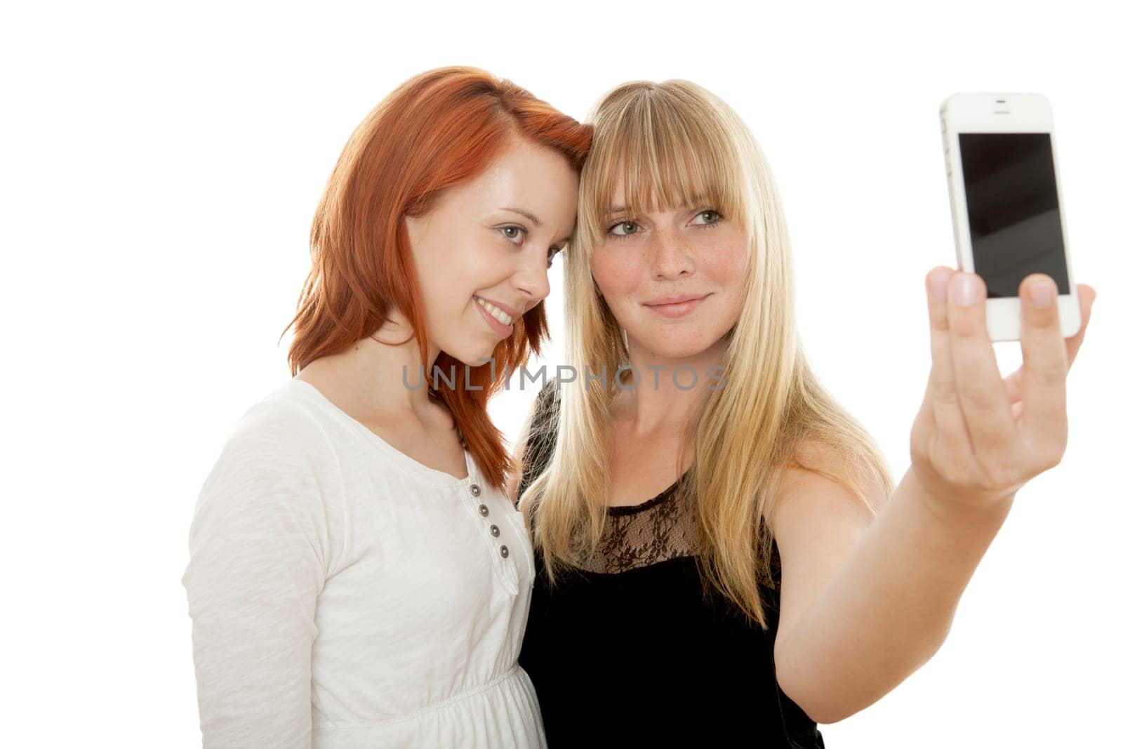 young beautiful red and blond haired girls in front of white background