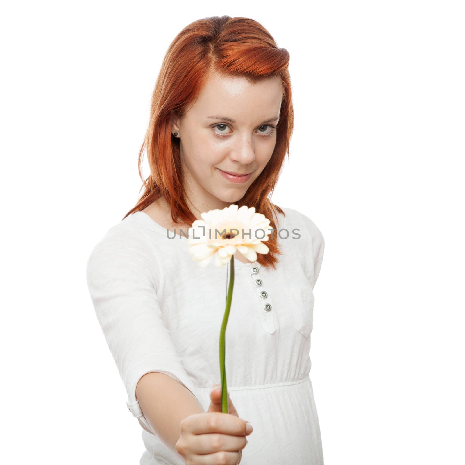young beautiful red haired girl gives a flower to you in front of white background