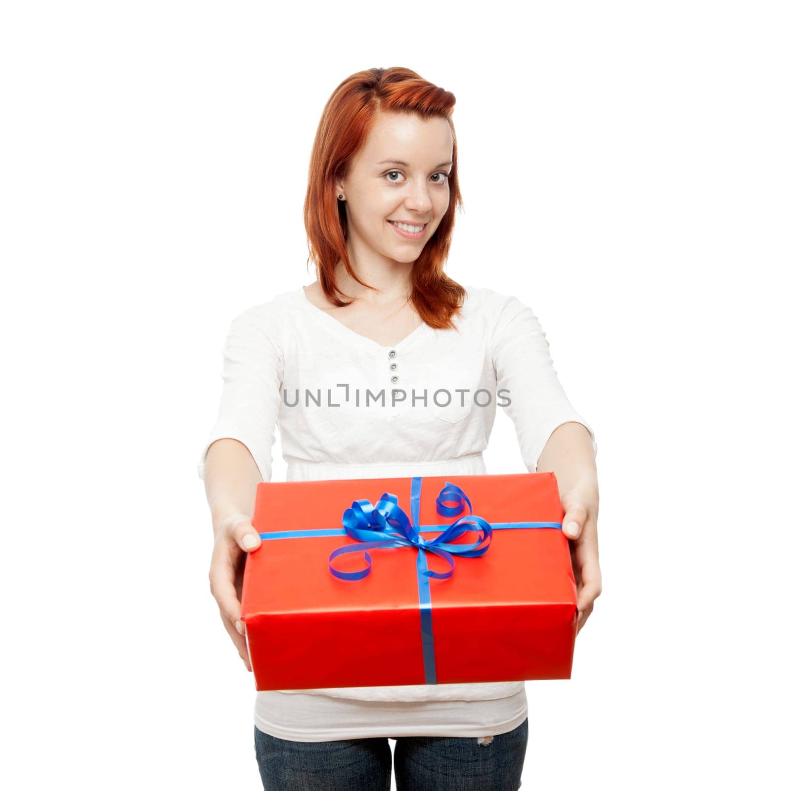 young beautiful red haired girl has a gift for you in front of white background
