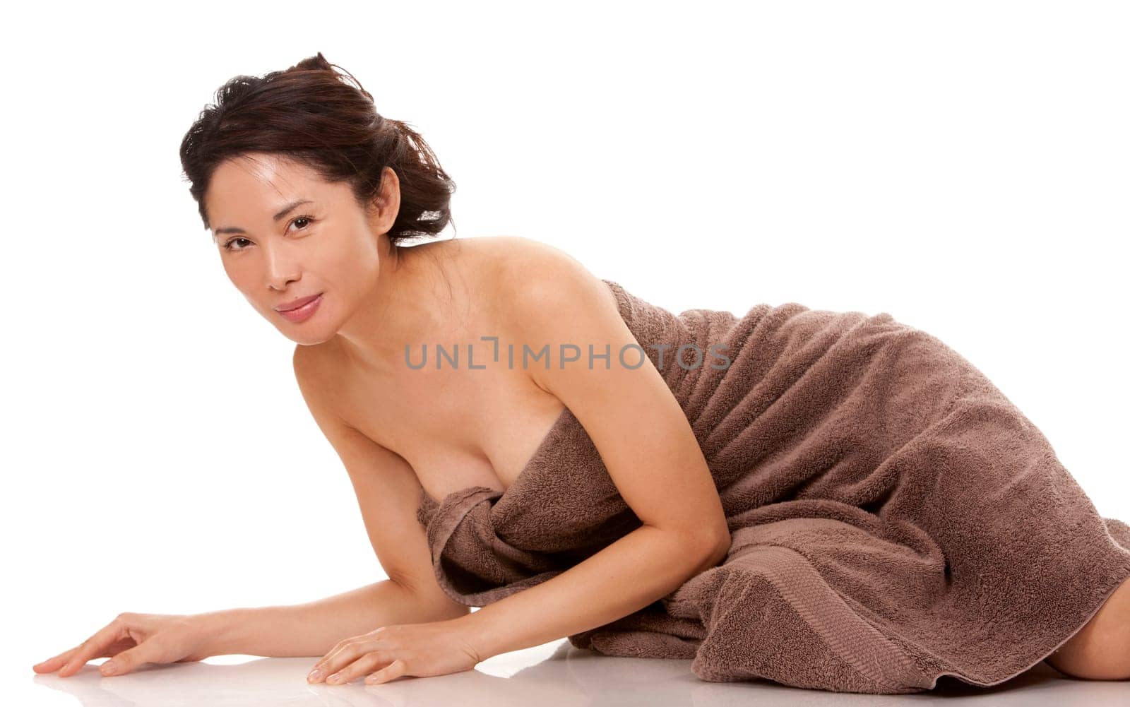 beautiful asian brunette wearing brown towel on white background