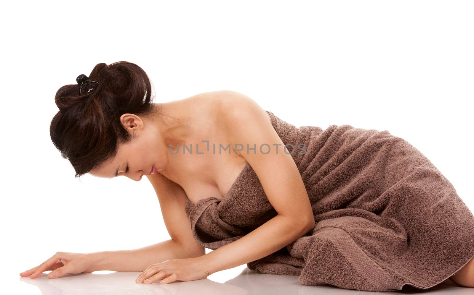 beautiful asian brunette wearing brown towel on white background