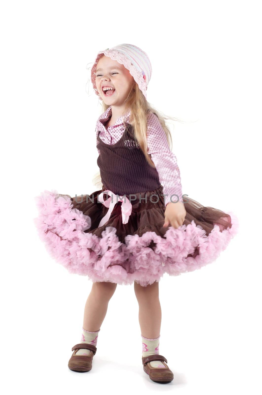 Shot of little laughing girl with long blond hair in studio