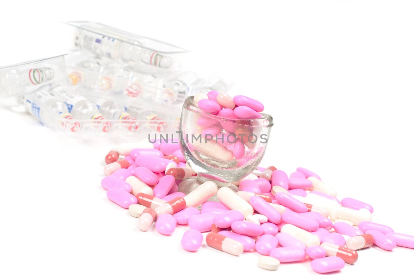 Shot of pink drugs (tablets) isolated on white