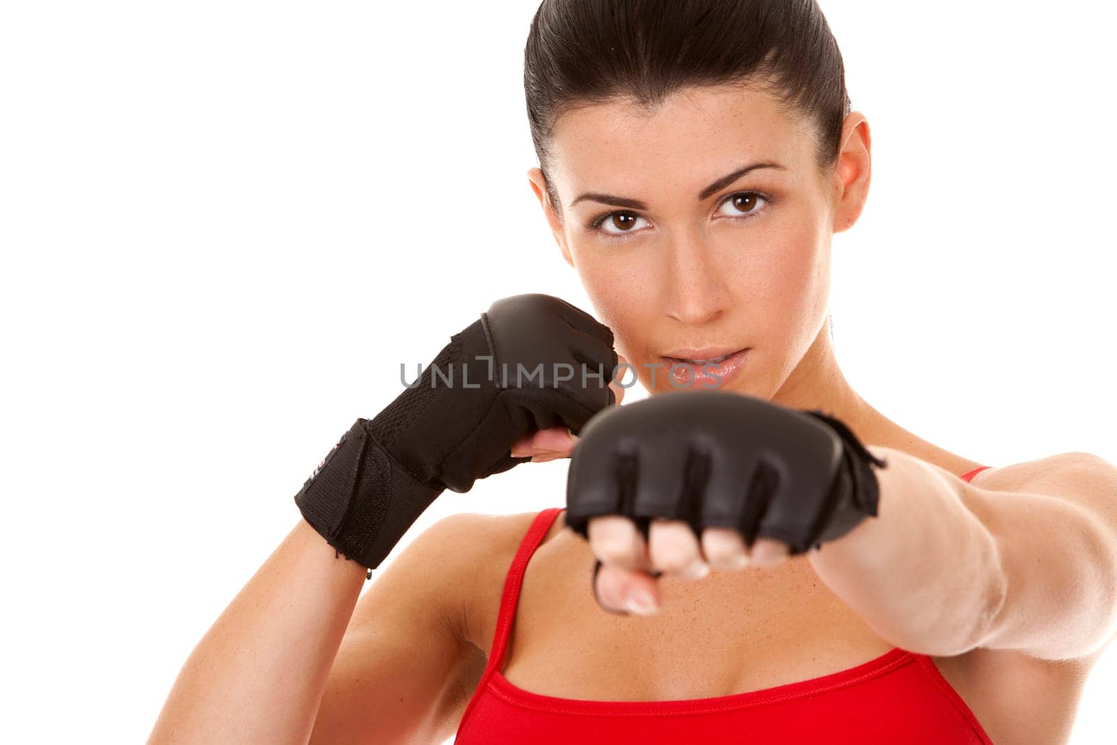 athletic brunette wearing boxing gloves on white isolated background