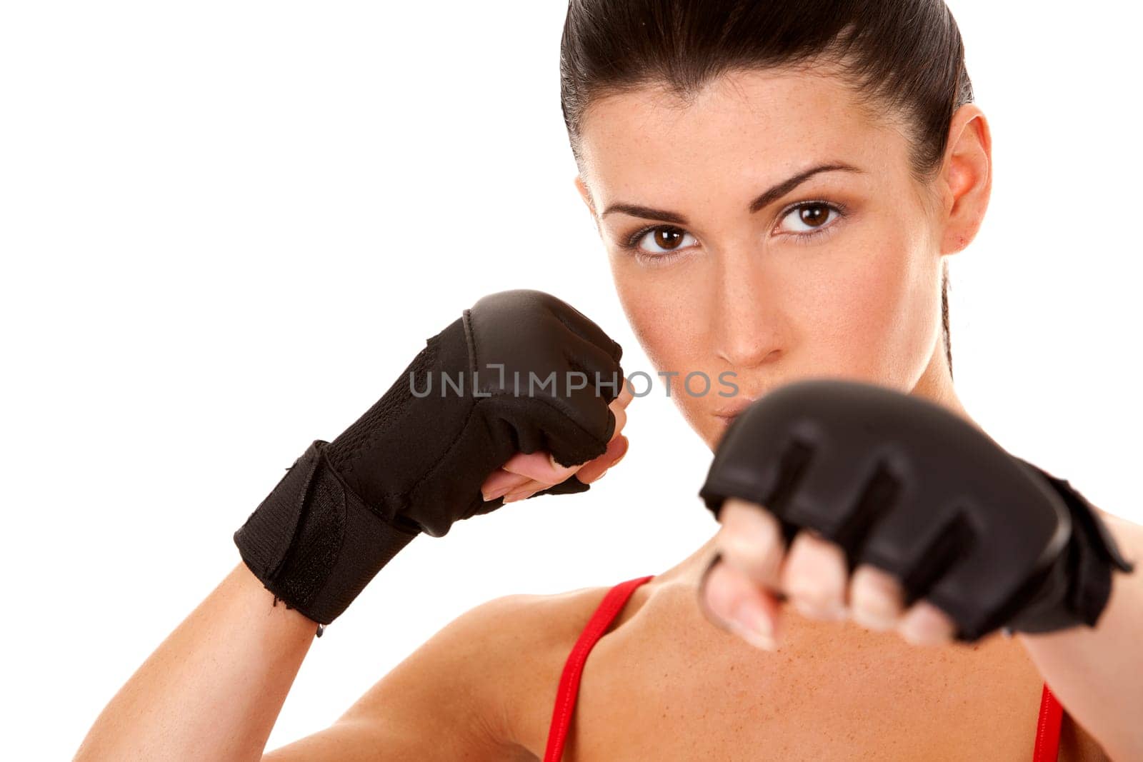 athletic brunette wearing boxing gloves on white isolated background