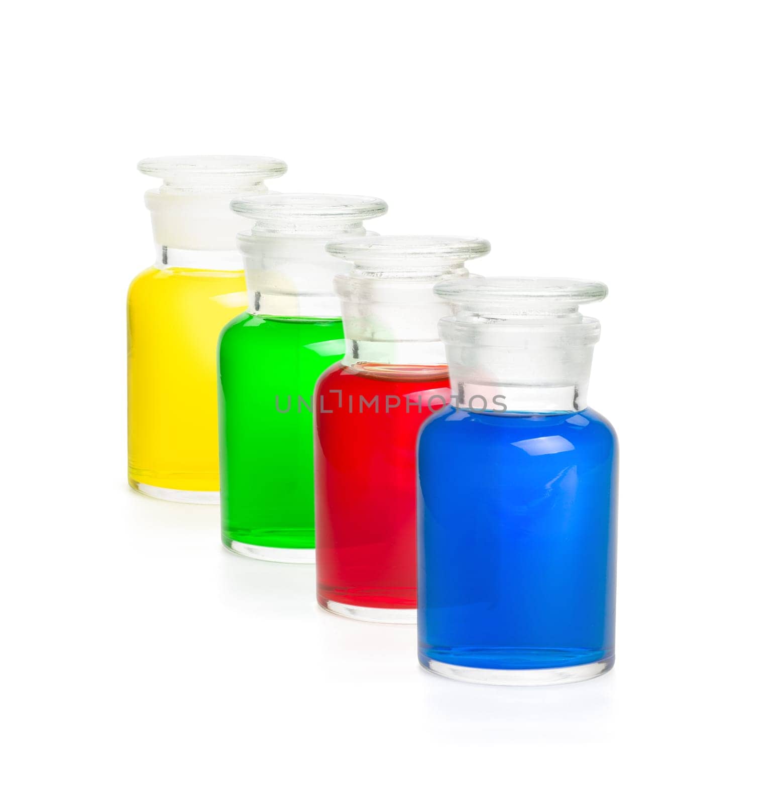 Four laboratory bottles filled with colorful liquids