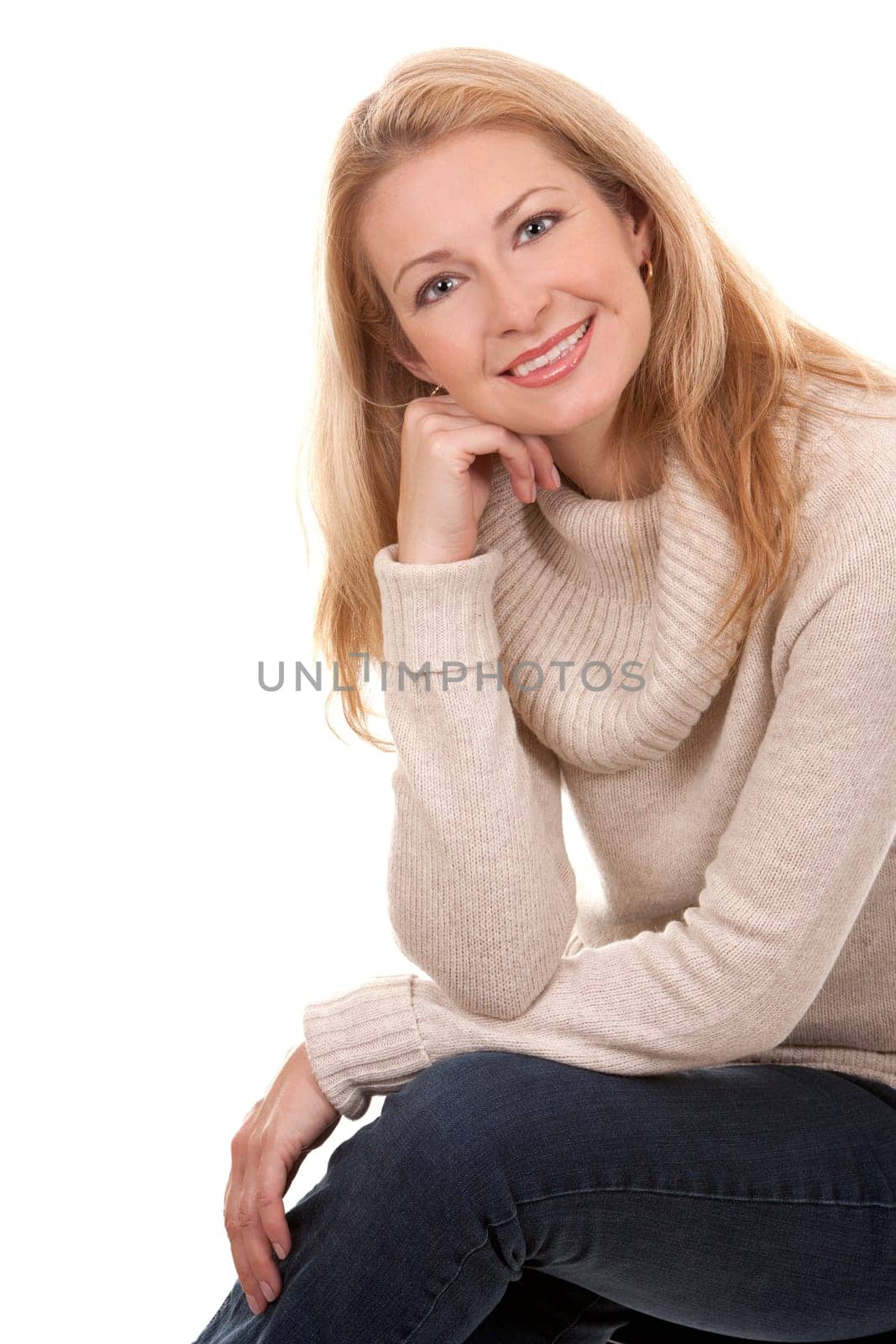 pretty blond woman wearing beige sweather on white background