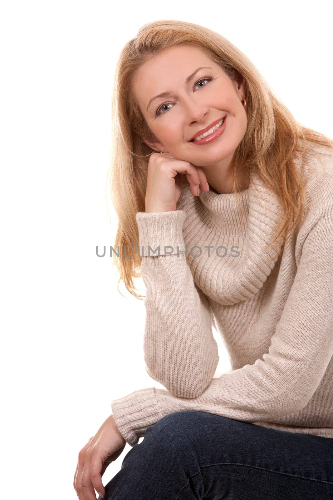 pretty blond woman wearing beige sweather on white background