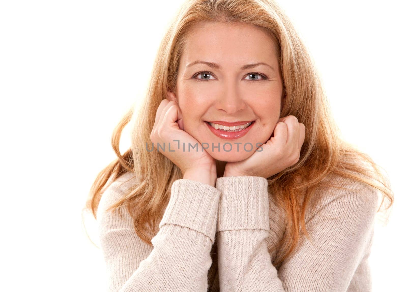 pretty blond woman wearing beige sweather on white background