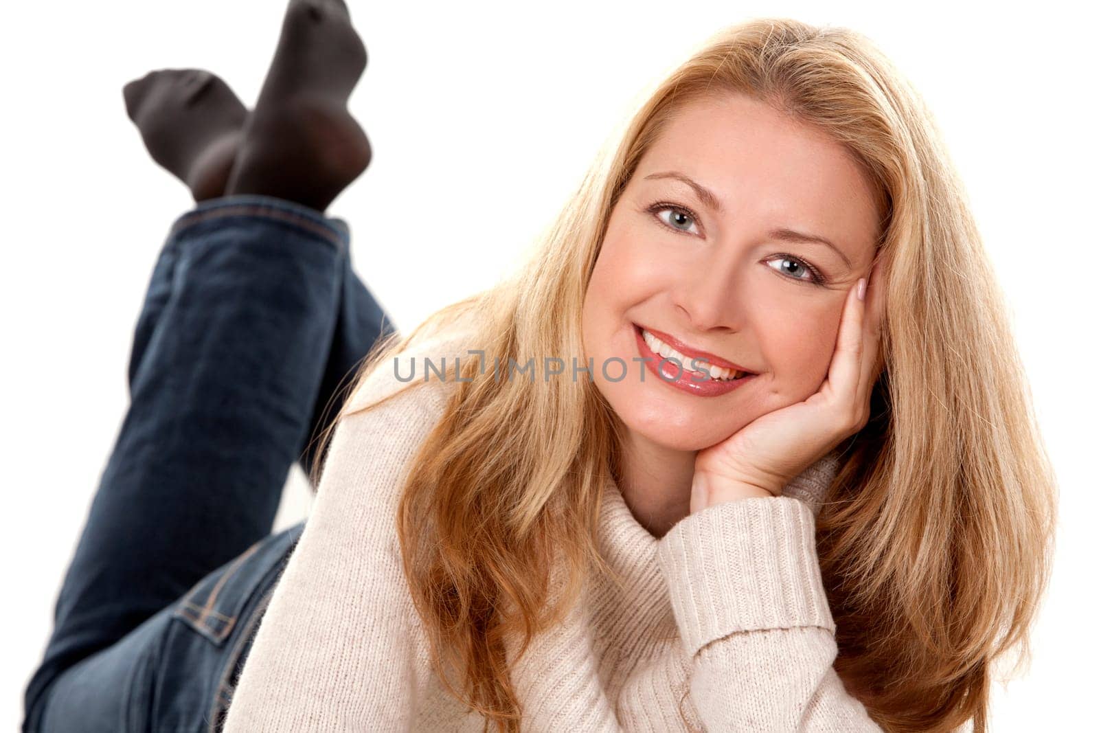 pretty blond woman wearing beige sweather on white background