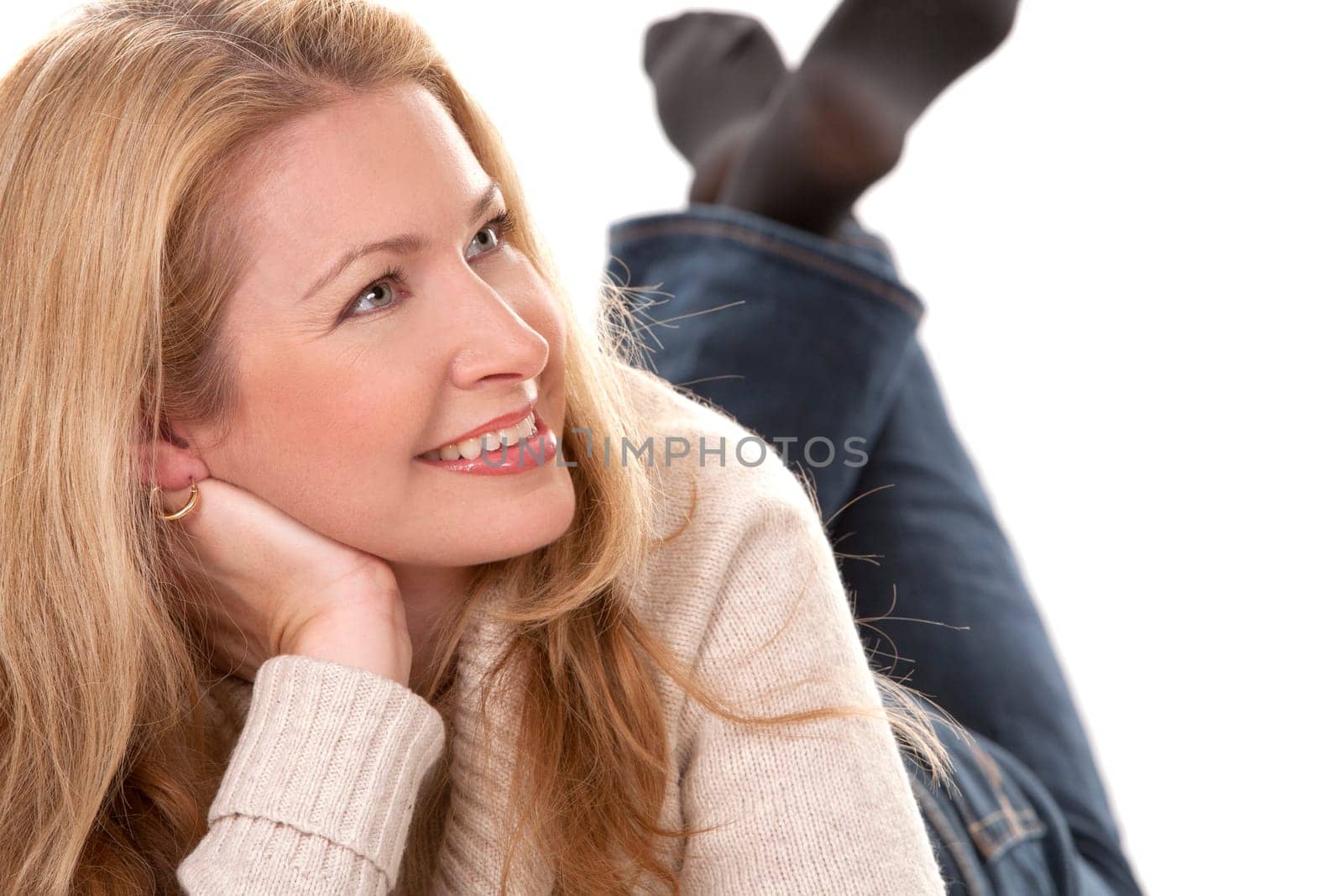 pretty blond woman wearing beige sweather on white background