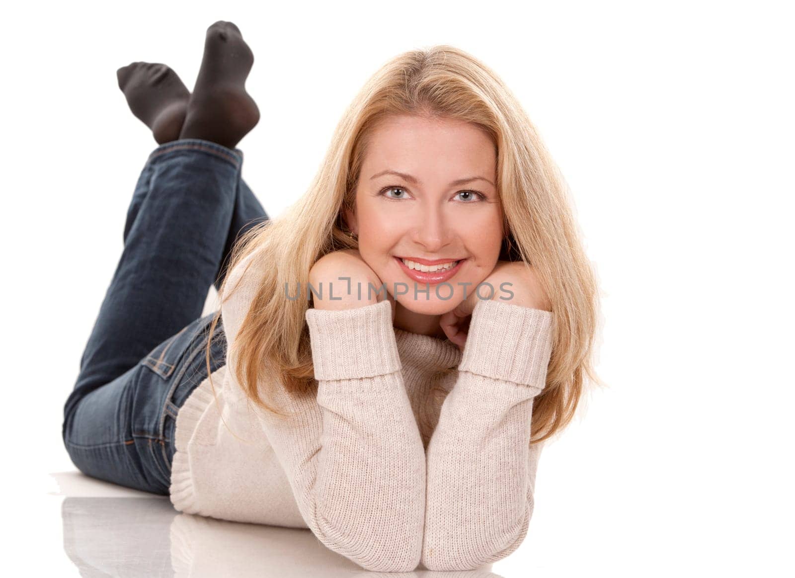 pretty blond woman wearing beige top sitting on white background