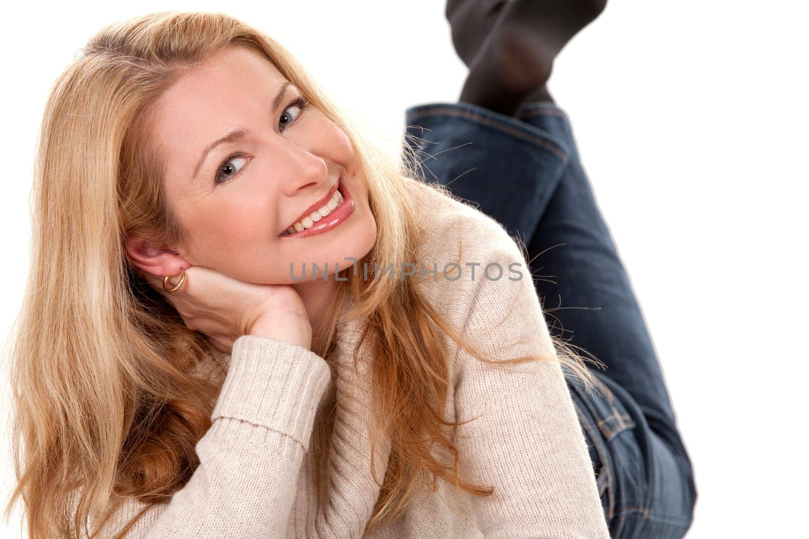pretty blond woman wearing beige sweather on white background