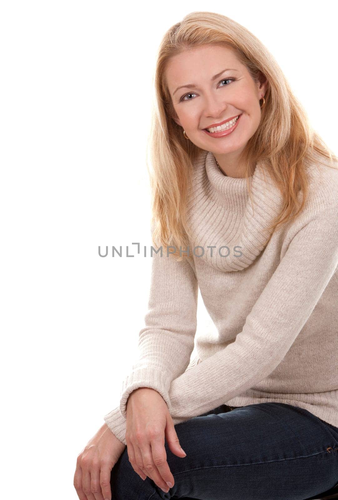 pretty blond woman wearing beige sweather on white background
