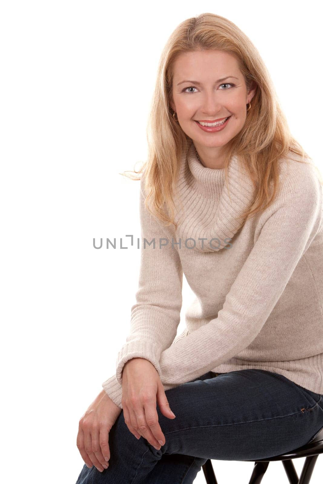 pretty blond woman wearing beige top sitting on white background