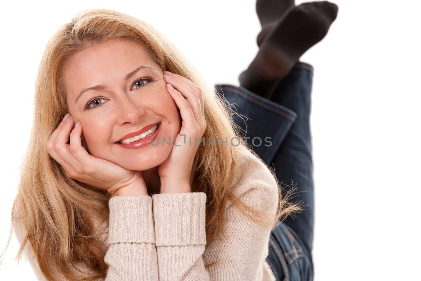 pretty blond woman wearing beige sweather on white background
