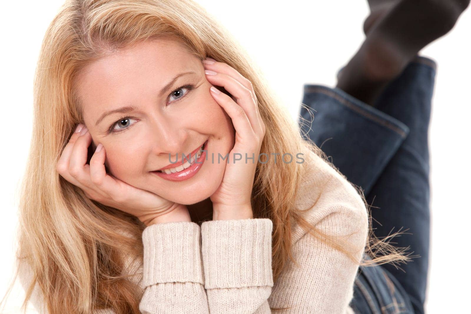 pretty blond woman wearing beige sweather on white background