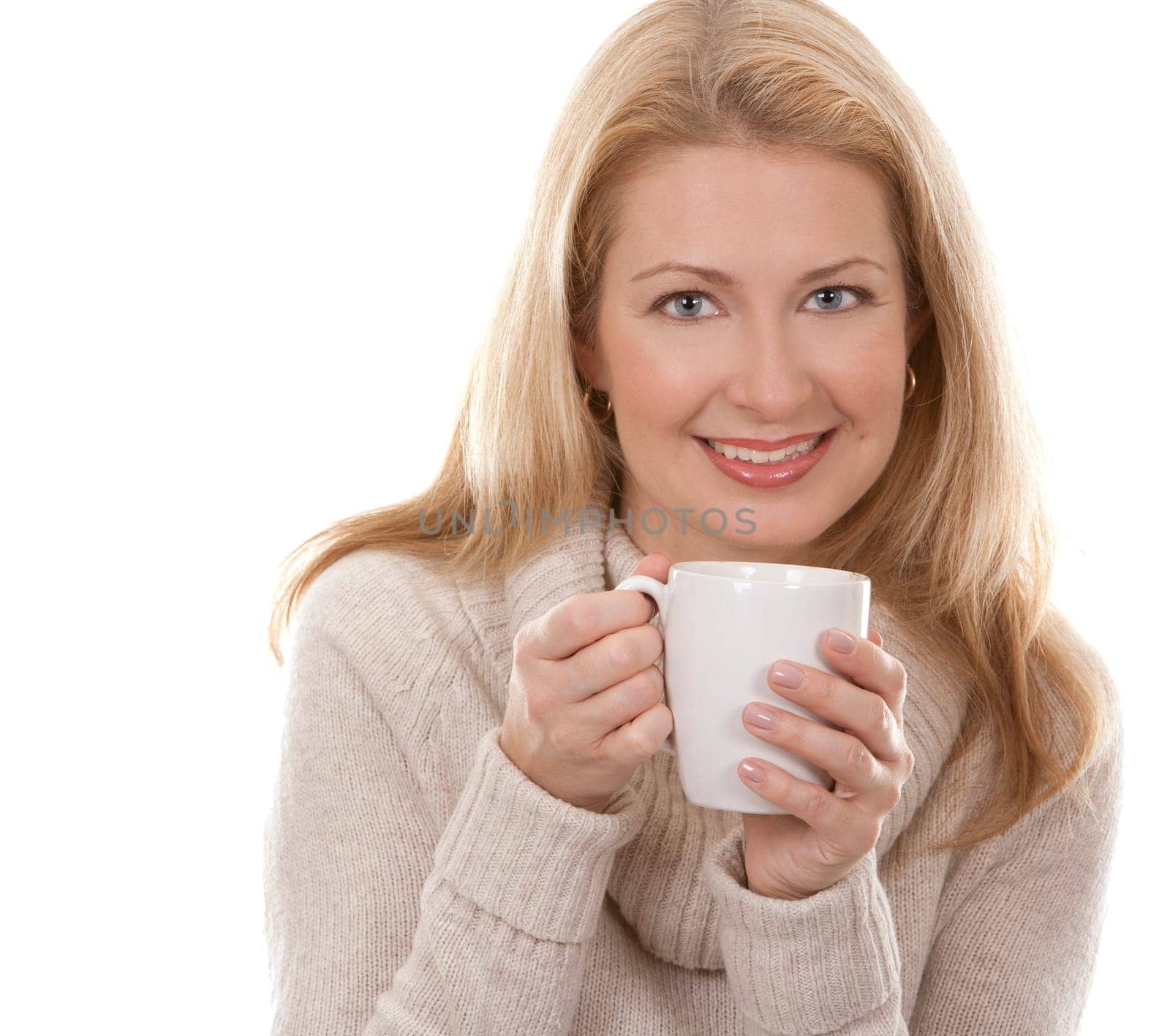 pretty blond woman wearing beige sweather drinking coffee