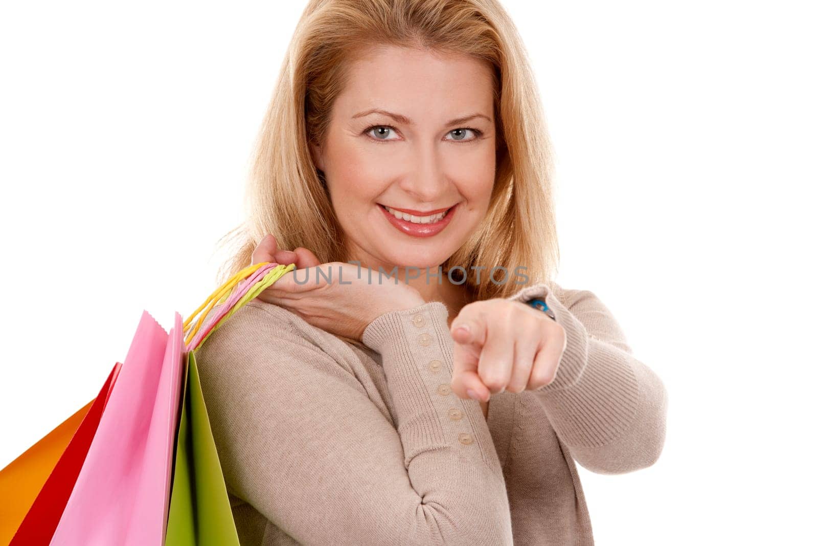 pretty blond woman wearing beige sweather holding shopping bags