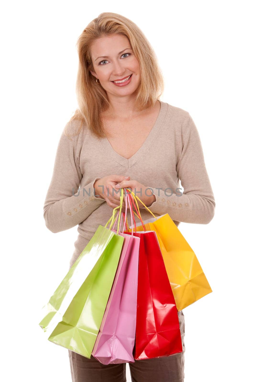 pretty blond woman wearing beige sweather holding shopping bags