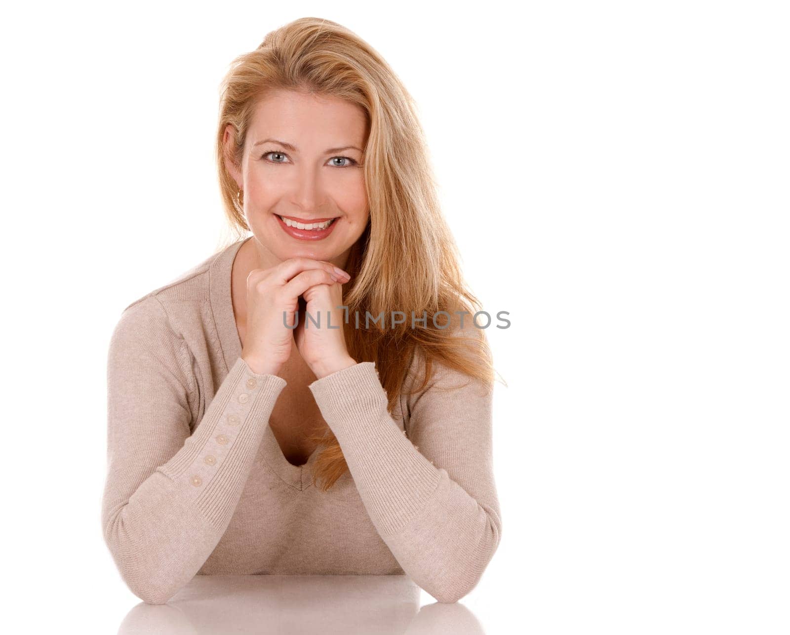 pretty blond woman wearing beige top sitting on white background
