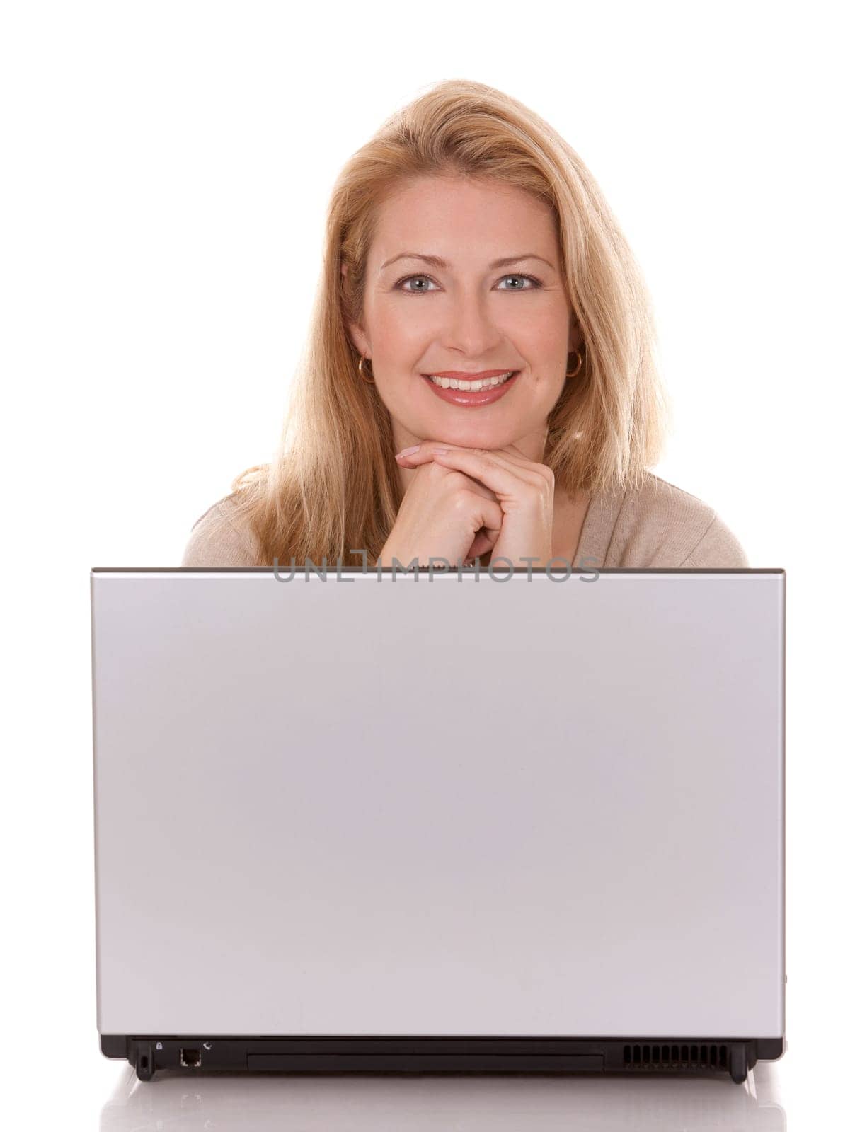 pretty blond woman wearing beige swether, sitting down and using laptop