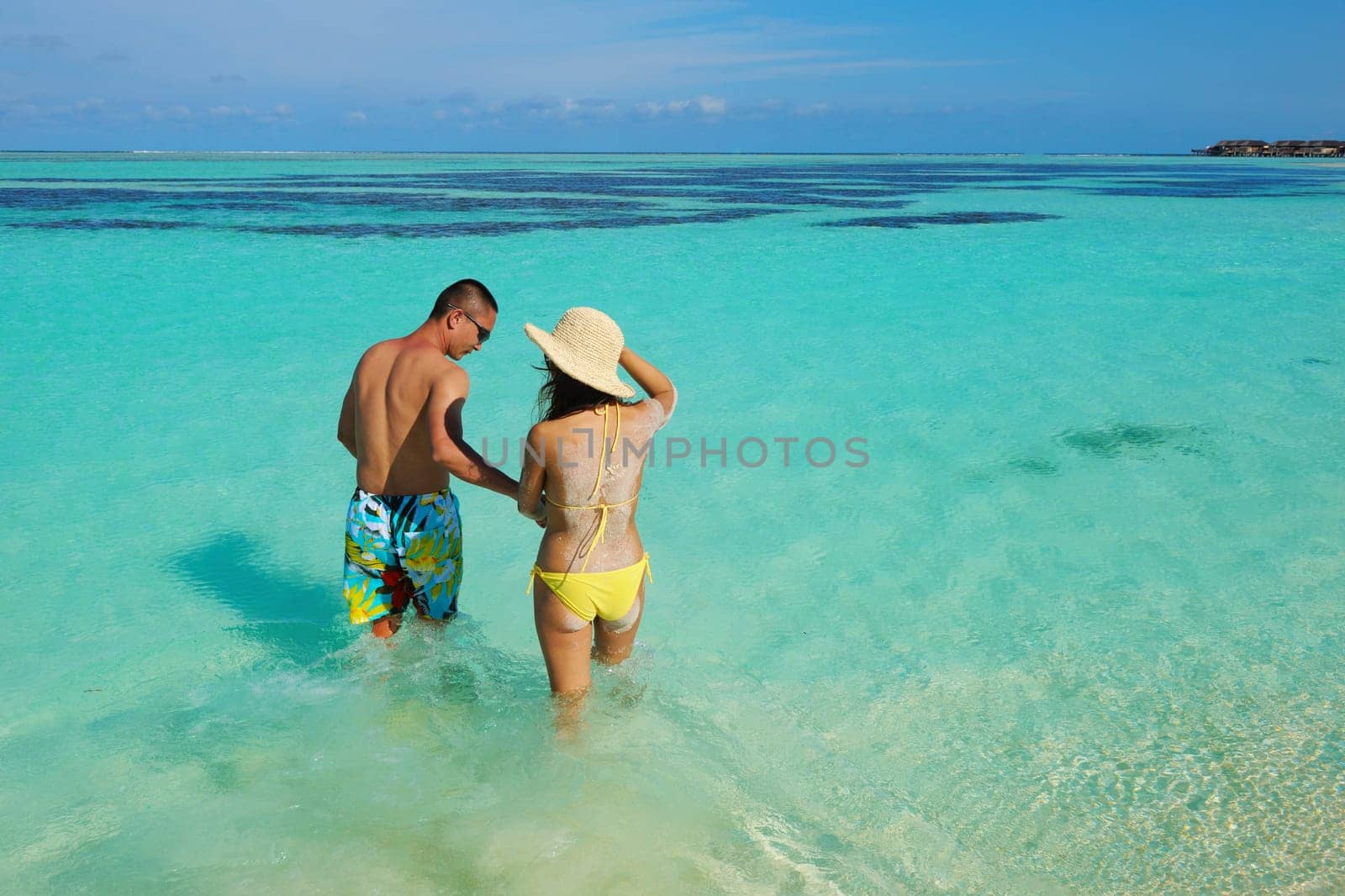 happy young asian couple enjoying summer and have on beautiful white sand beach
