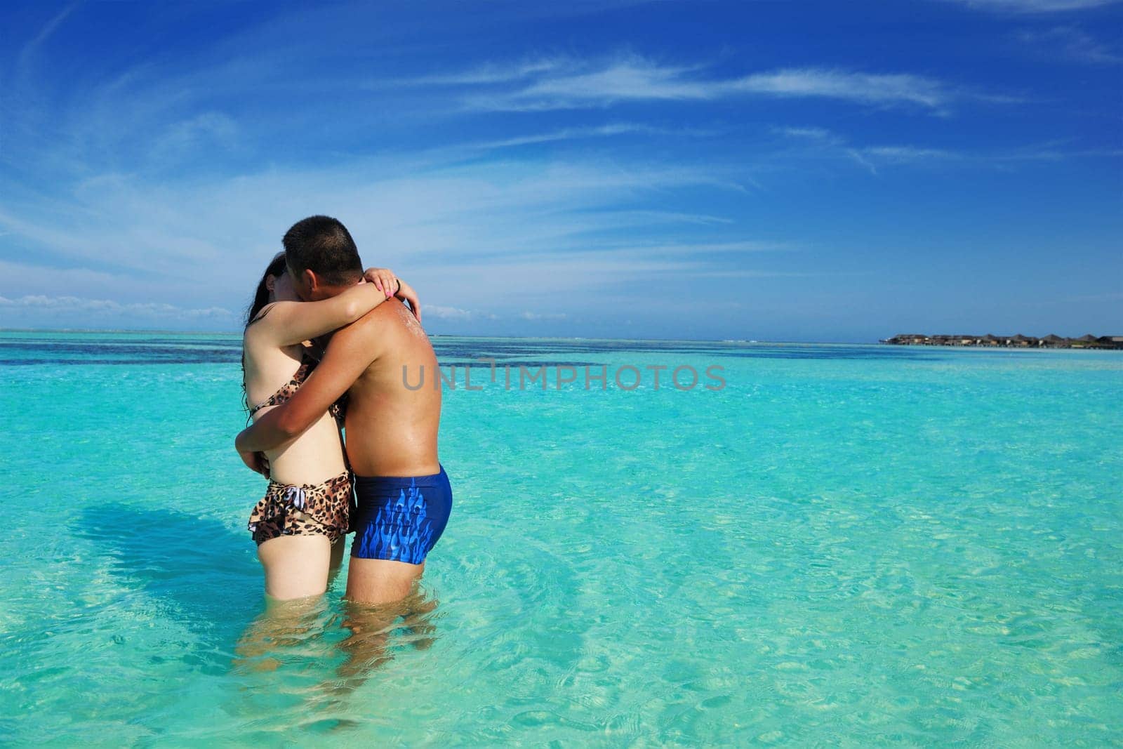 happy young asian couple enjoying summer and have on beautiful white sand beach