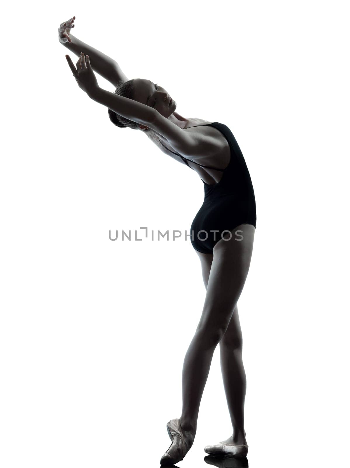 one caucasian young woman ballerina ballet dancer stretching warming up in silhouette studio on white background