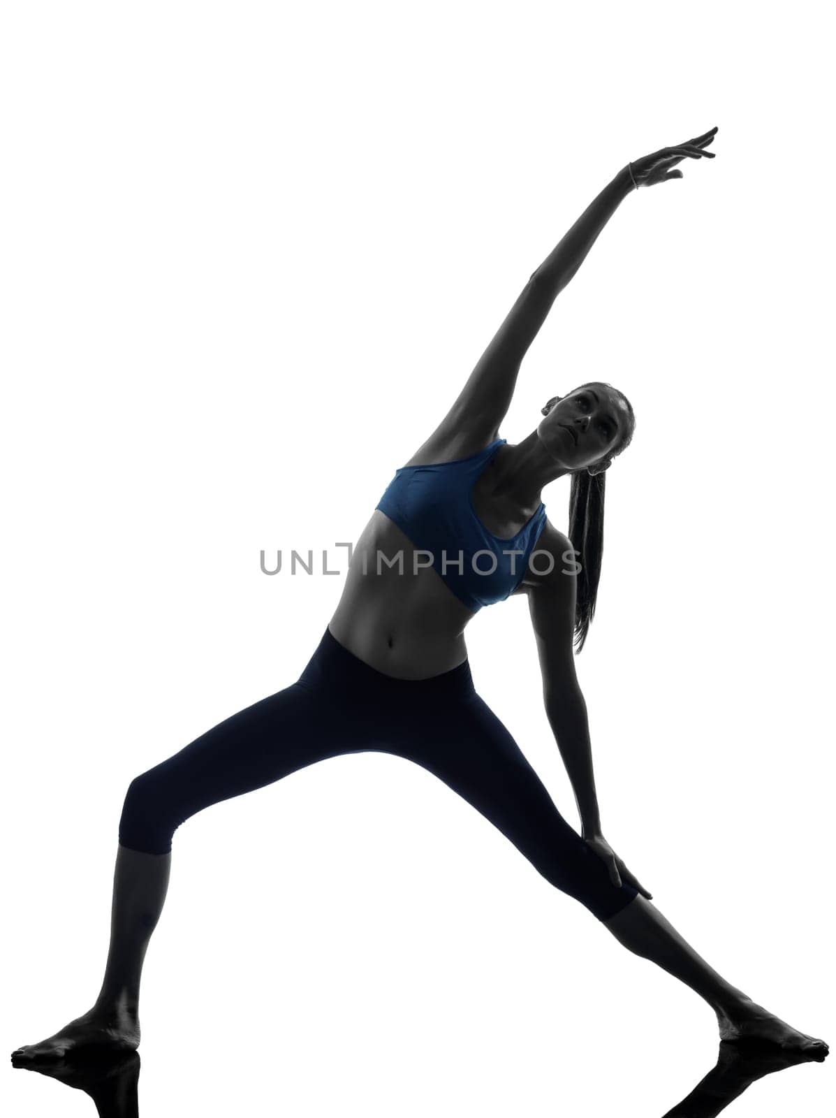 one caucasian woman exercising stretching triangle pose yoga in silhouette studio isolated on white background