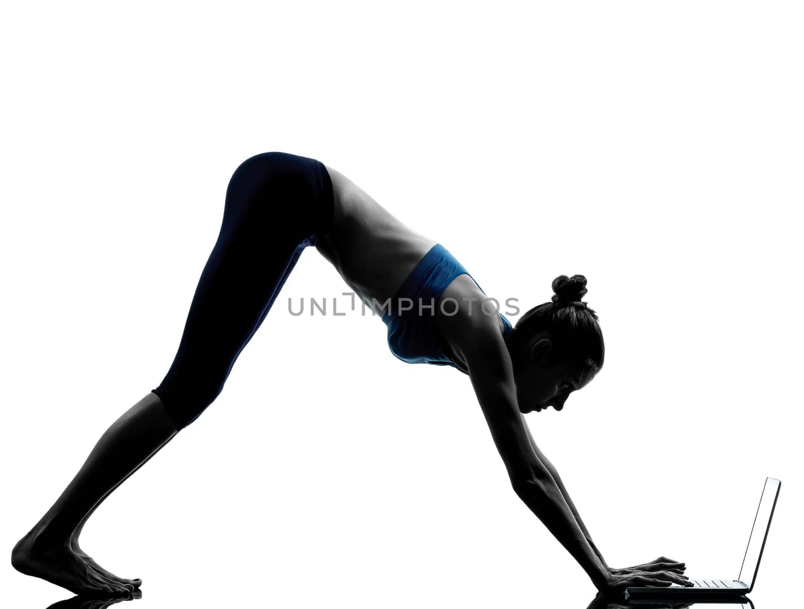 one caucasian woman exercising yoga  using computer laptop in silhouette studio isolated on white background
